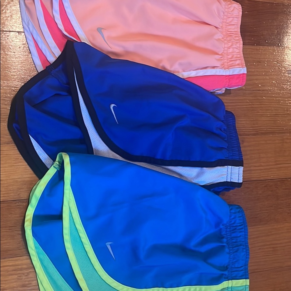 Three pairs of Nike running shorts